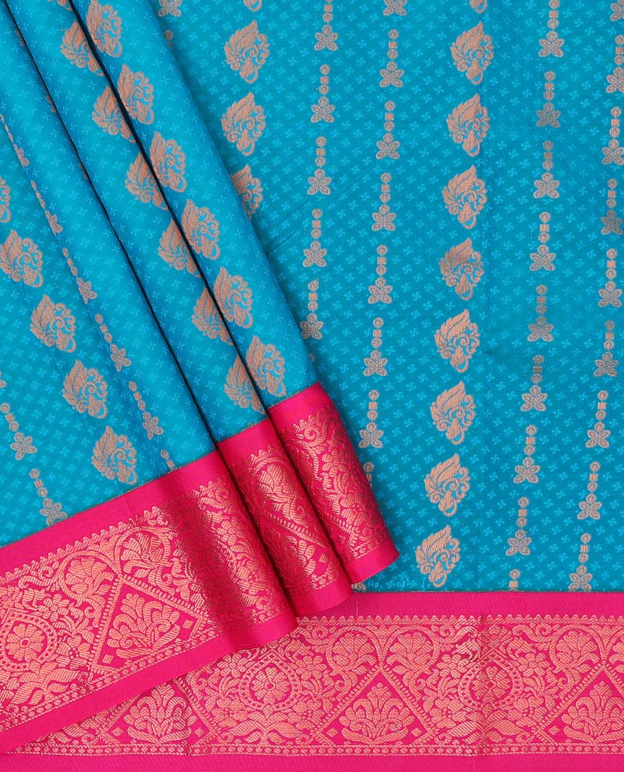 Blue embossed art-silk pavadai with zari buttes, contrast blouse & border of traditional designs