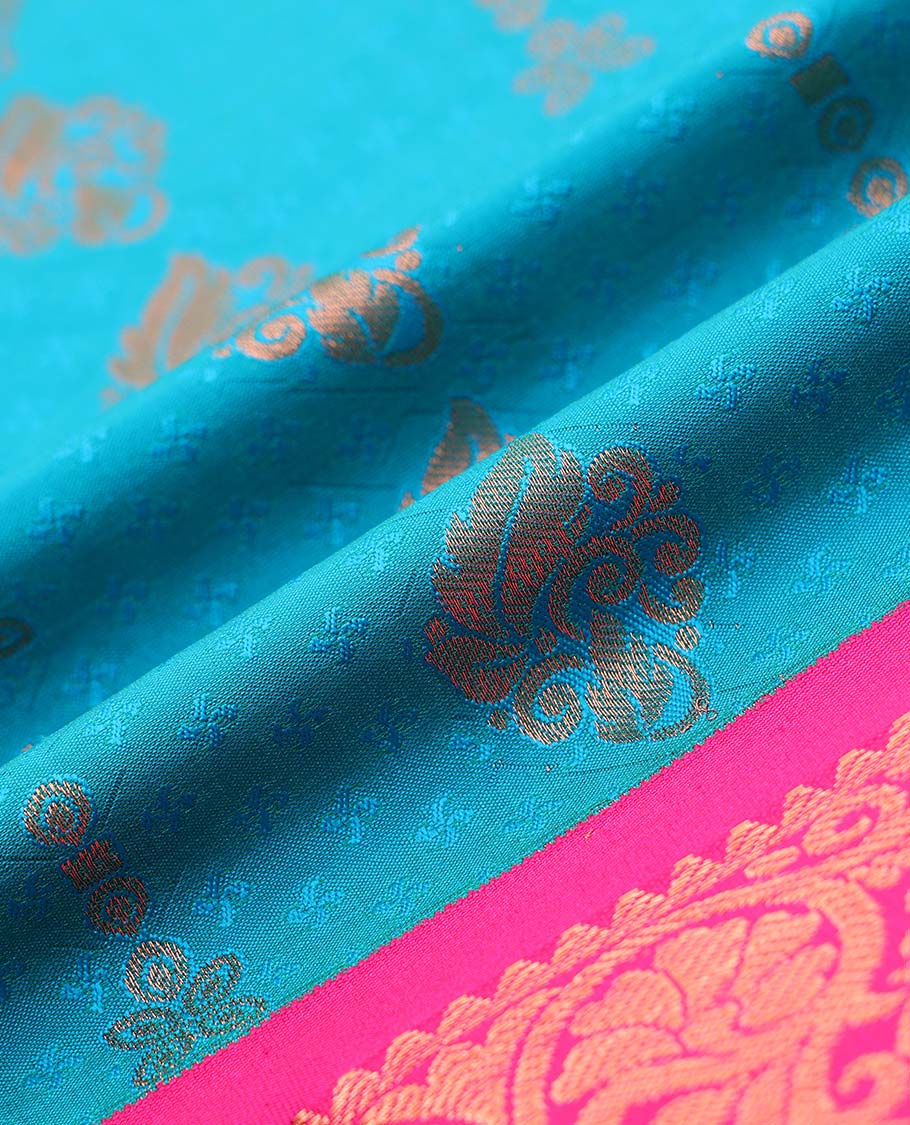 Blue embossed art-silk pavadai with zari buttes, contrast blouse & border of traditional designs