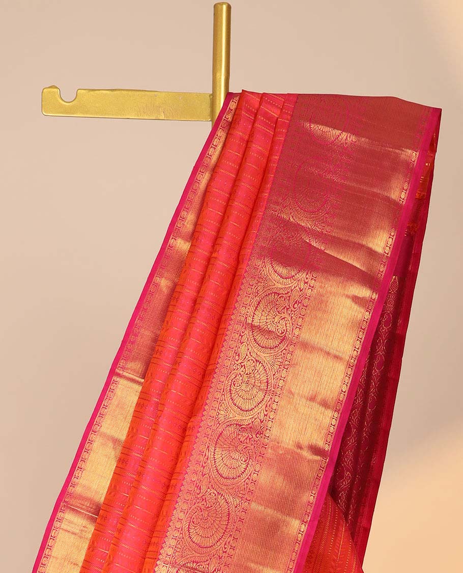Orange embossed silk saree, contrast paisley pallu & border of thilakam mokku,poun,kodi visiry,banaras & zari stripes