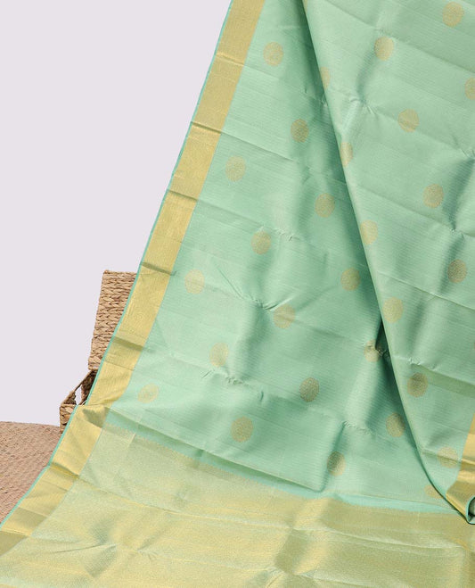 Green embossed silksaree with zari buttas, jaal pallu & zari border of muthu & vanki designs