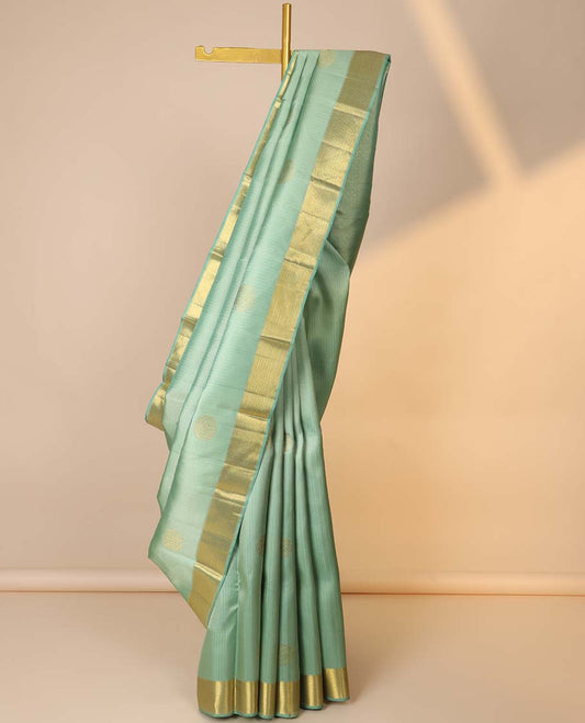 Green embossed silksaree with zari buttas, jaal pallu & zari border of muthu & vanki designs