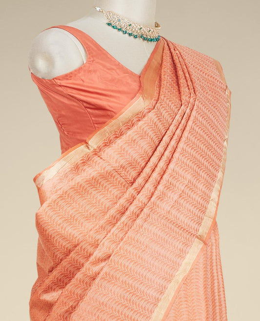 Orange intricately designed tusser silk saree, plain border