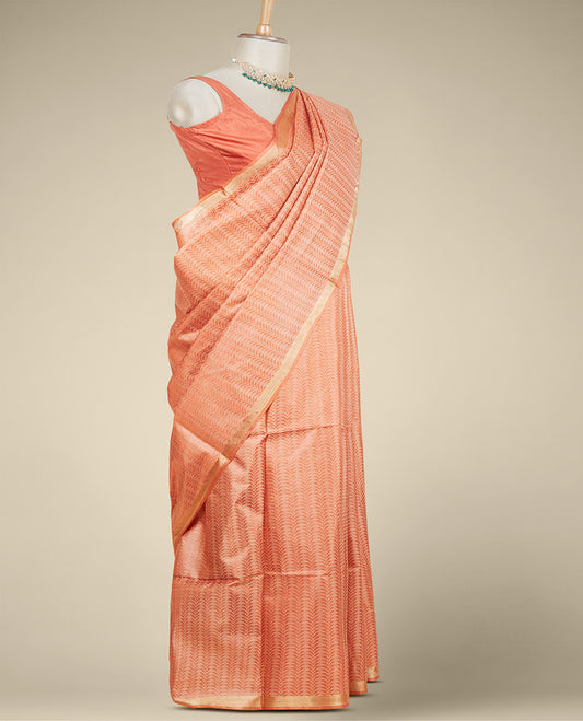 Orange intricately designed tusser silk saree, plain border