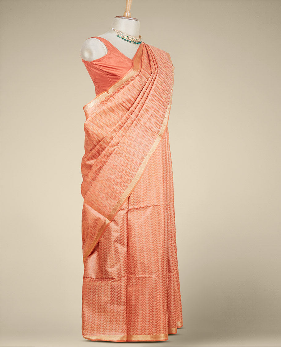 Orange intricately designed tusser silk saree, plain border