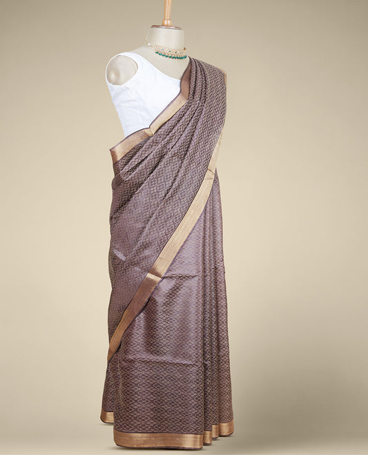 Brown spare intricate ogee patterned tusser silk saree with plain border