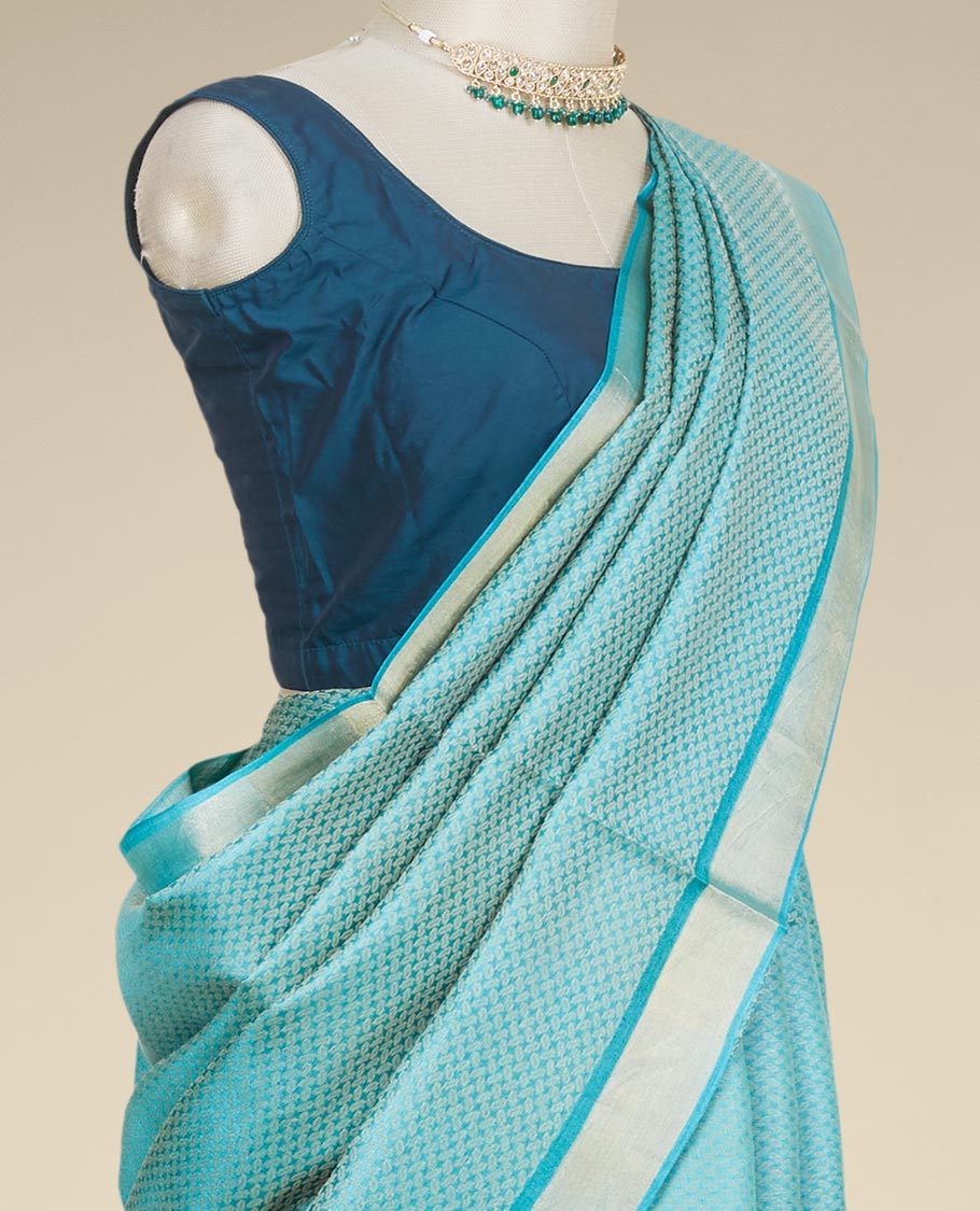 Green intricately designed tusser silk saree, plain border