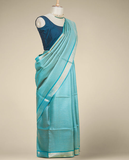 Green intricately designed tusser silk saree, plain border