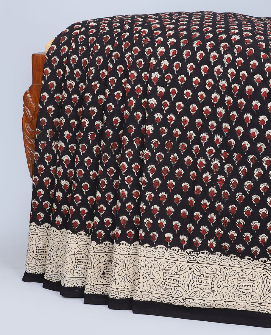 Black floral motifs printed mul-mul cotton saree, fish printed border & pallu of intricate print 