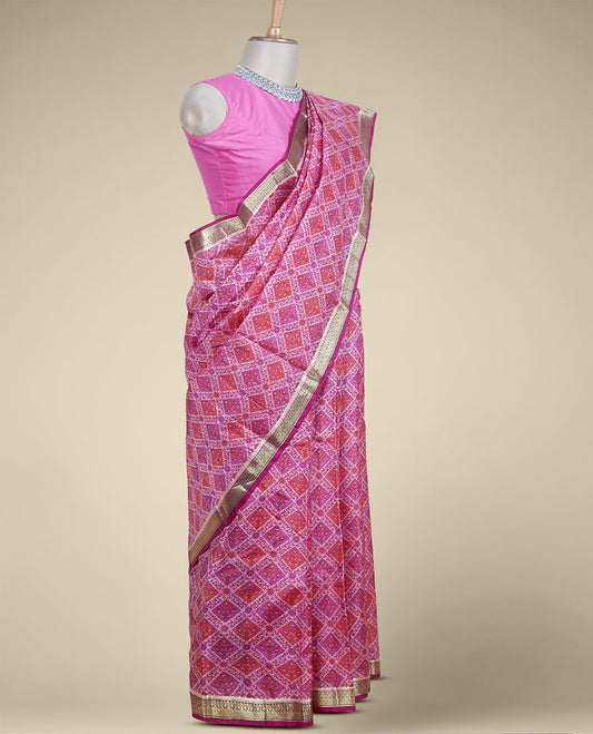 Pink floral butta enclosed diamond patterns printed silk saree, contrast traditional zari border