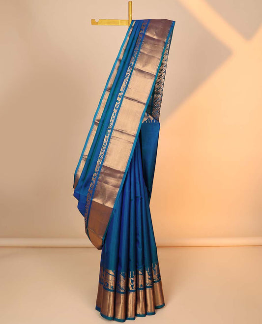 Blue plain silk saree, intricate pallu & weeding-themed figurines zari woven border of rekku & poun designs