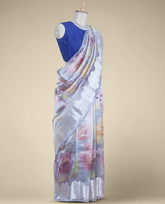 Grey colorful floral printed tissue silk saree, zari border steeped with floral designs