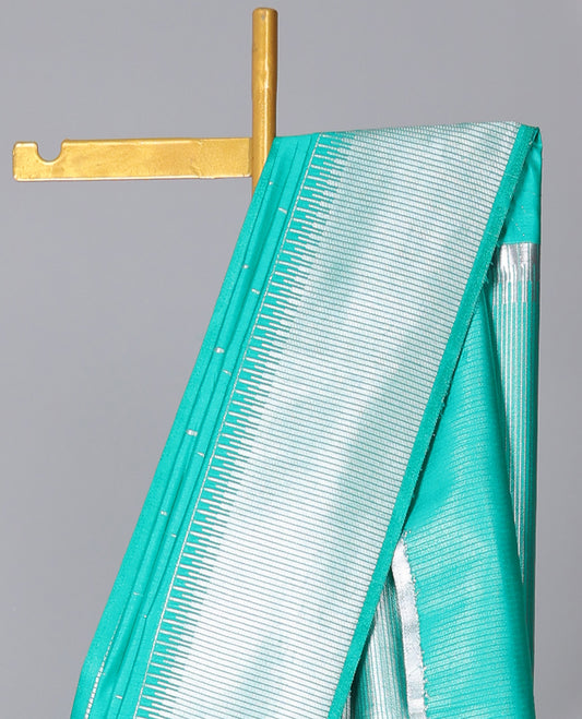 Turquoise semi-banaras dola silk saree with buttas, zari-rich traditional temple border, and pallu