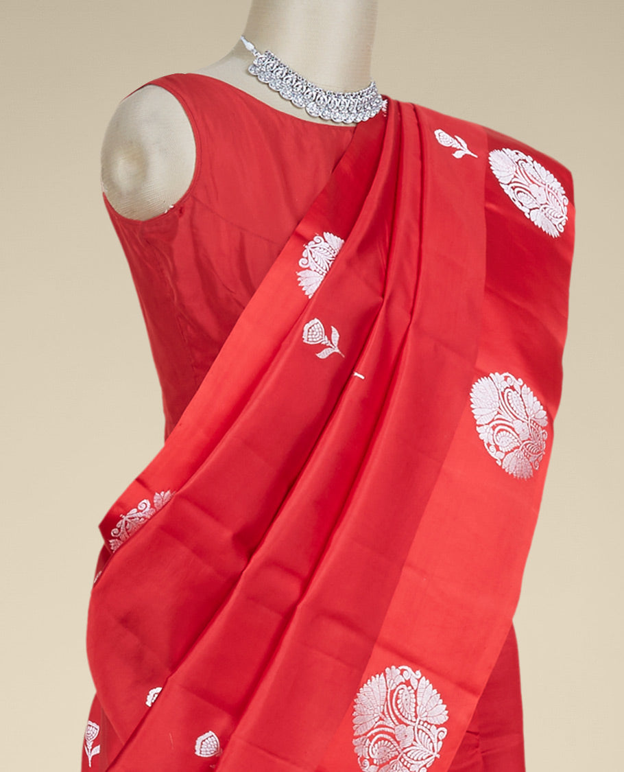 Red banaras raw mango silk saree features floral zari buttas, intricate floral zari design border