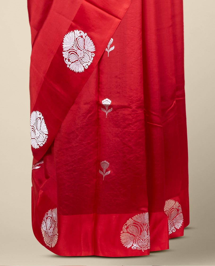 Red banaras raw mango silk saree features floral zari buttas, intricate floral zari design border