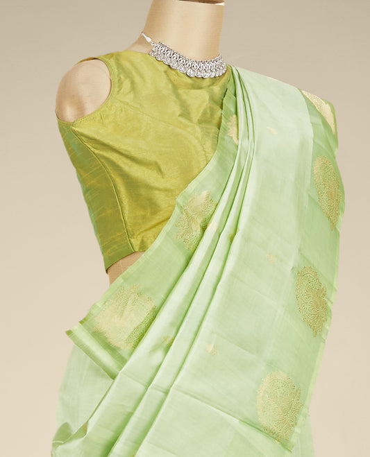 Green banaras raw mango silk saree with zari buttas, contrast border of intricate floral designs