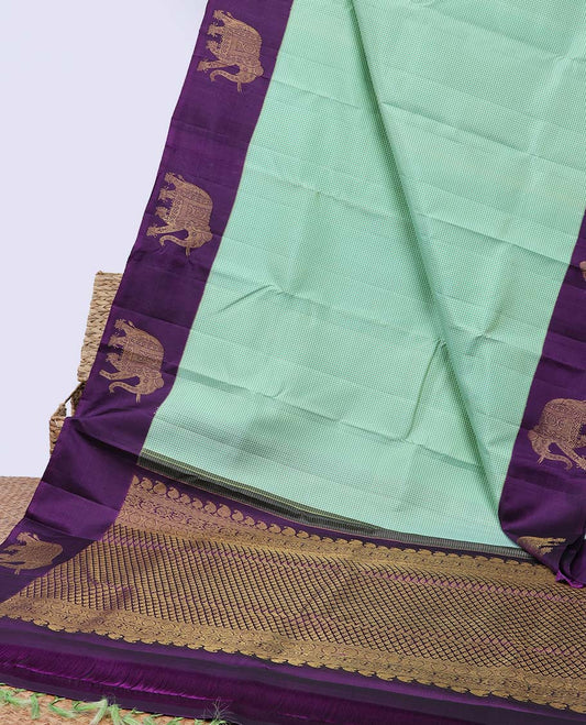 Green micro-checked kancheepuram silksaree, contrast yaanai motifs border & pallu of manga mokku,kodi visiry & jaal