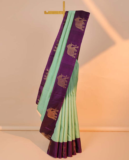 Green micro-checked kancheepuram silksaree, contrast yaanai motifs border & pallu of manga mokku,kodi visiry & jaal