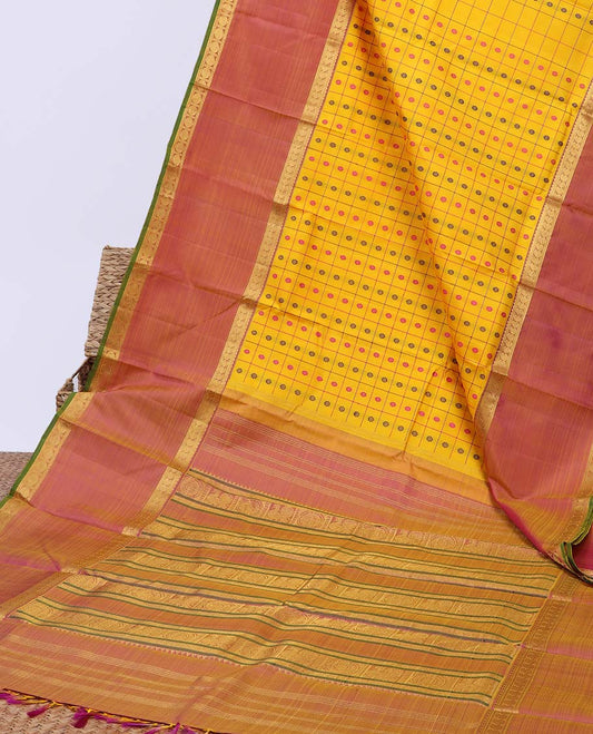 Yellow butta & check kancheepuram silksaree,contrast mayil chakra pallu & rettai petty border of rekku,neli,manga & poun