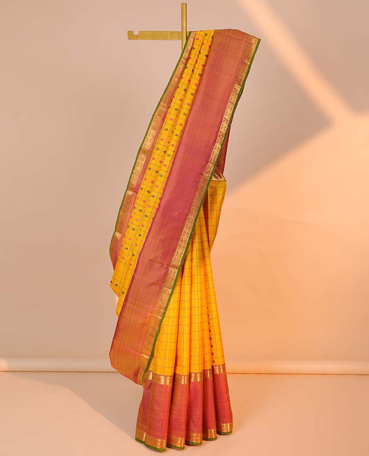 Yellow butta & check kancheepuram silksaree,contrast mayil chakra pallu & rettai petty border of rekku,neli,manga & poun