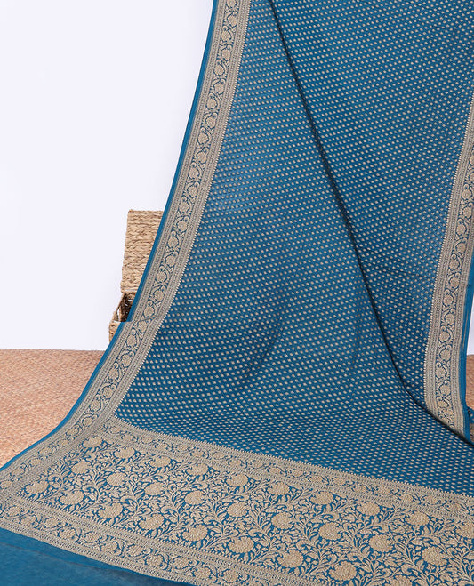 Blue khaddi georgette saree with buttas, floral jaal pallu & traditional border of floral creeper design
