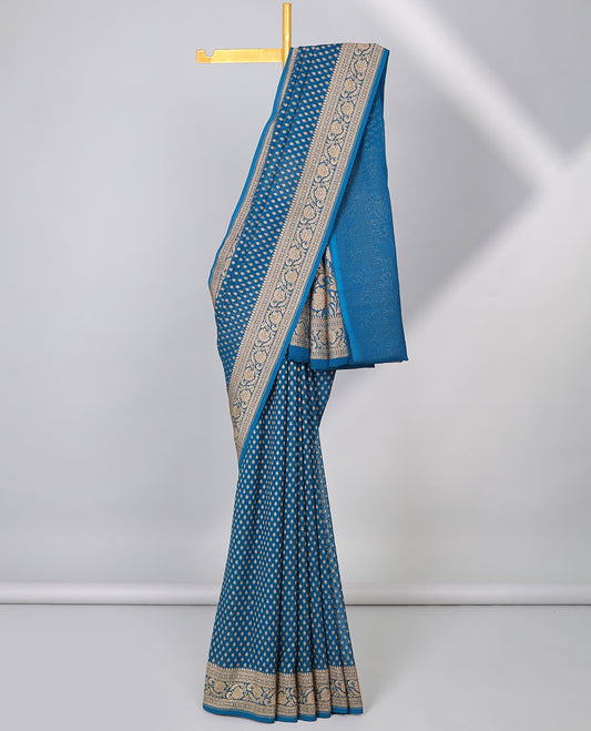 Blue khaddi georgette saree with buttas, floral jaal pallu & traditional border of floral creeper design