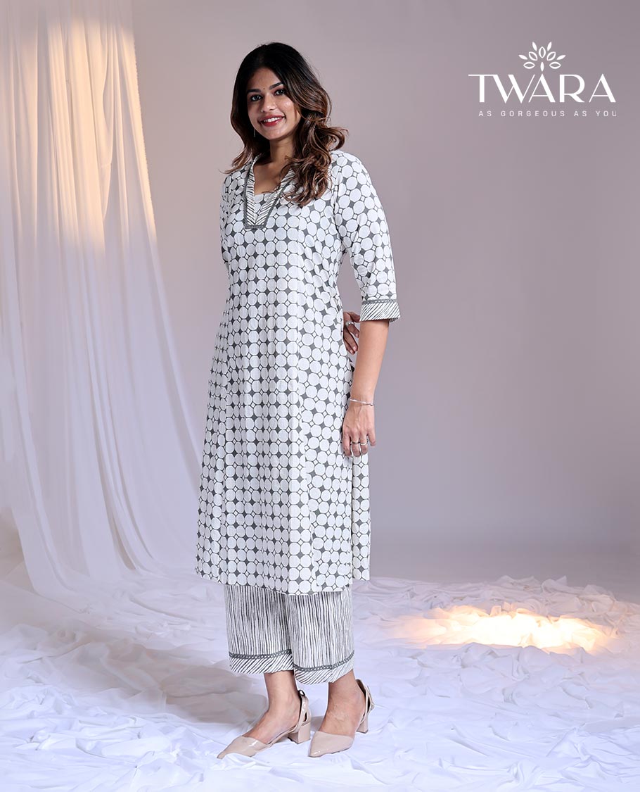 Twara White readymade suit, geometric printed 3/4th sleeve v-neck cotton top & printed pants