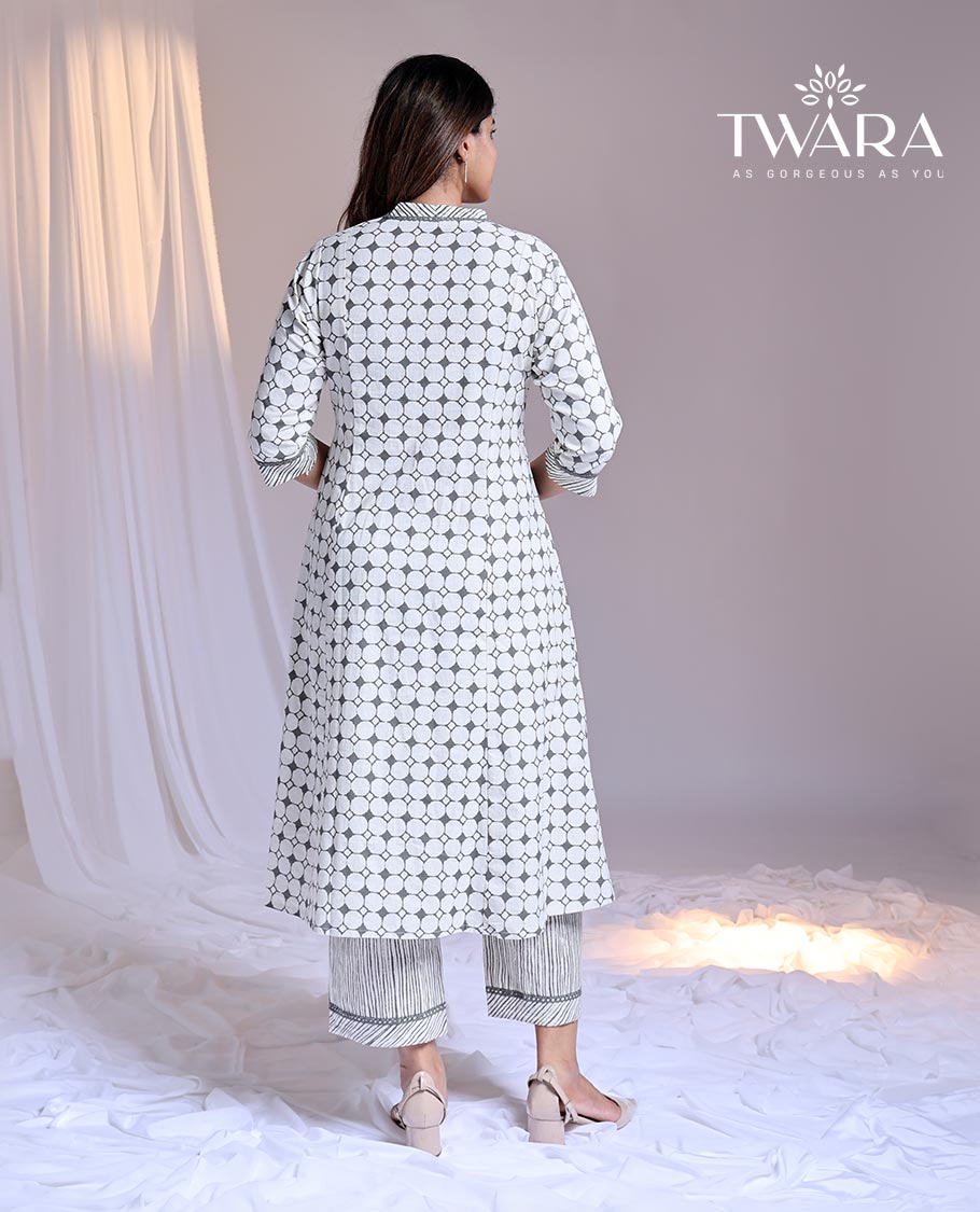 Twara White readymade suit, geometric printed 3/4th sleeve v-neck cotton top & printed pants