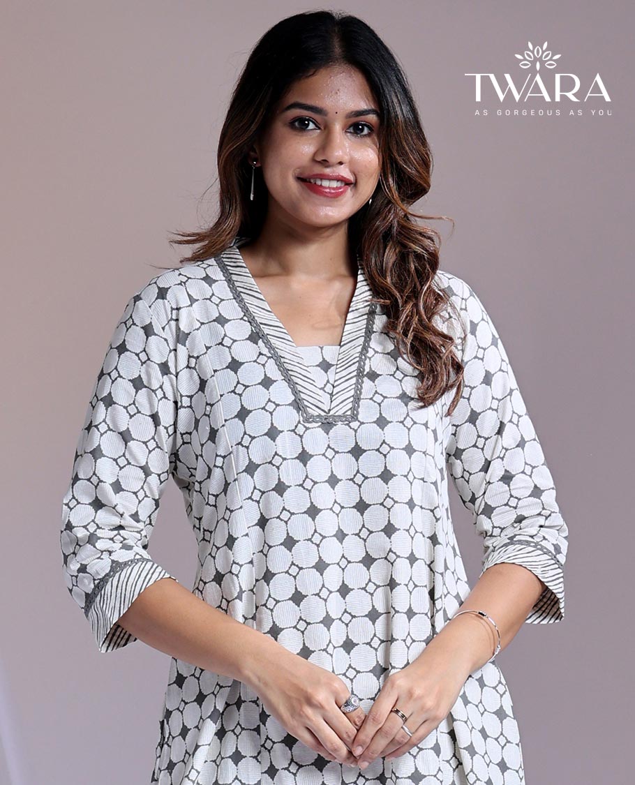 Twara White readymade suit, geometric printed 3/4th sleeve v-neck cotton top & printed pants