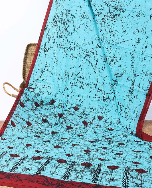 Blue batik printed mul-mul cotton saree, contrast batik border & batik printed pallu of floral motifs