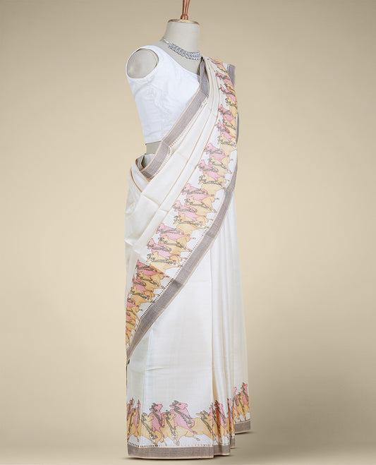 Cream plain design tusser silk saree features pichwai cow motifs, contrast border