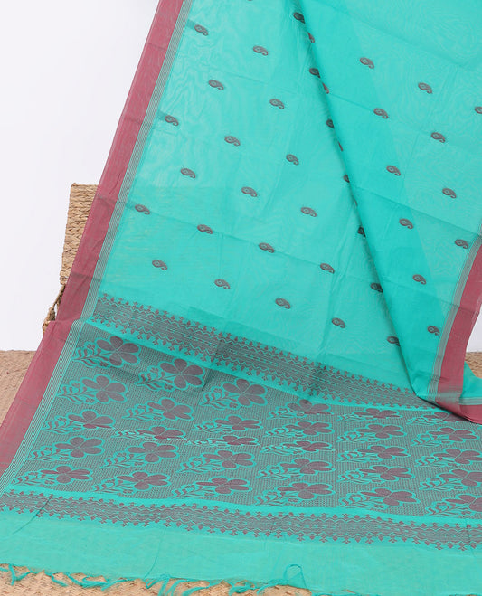 Blue kanchi cotton saree with paisley buttas, contrast plain border & floral design pallu