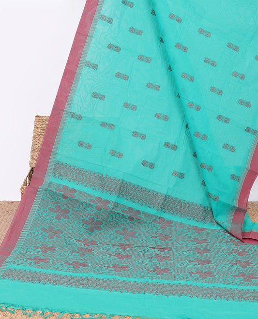 Blue kanchi cotton saree with floral buttas, contrast border & floral design pallu