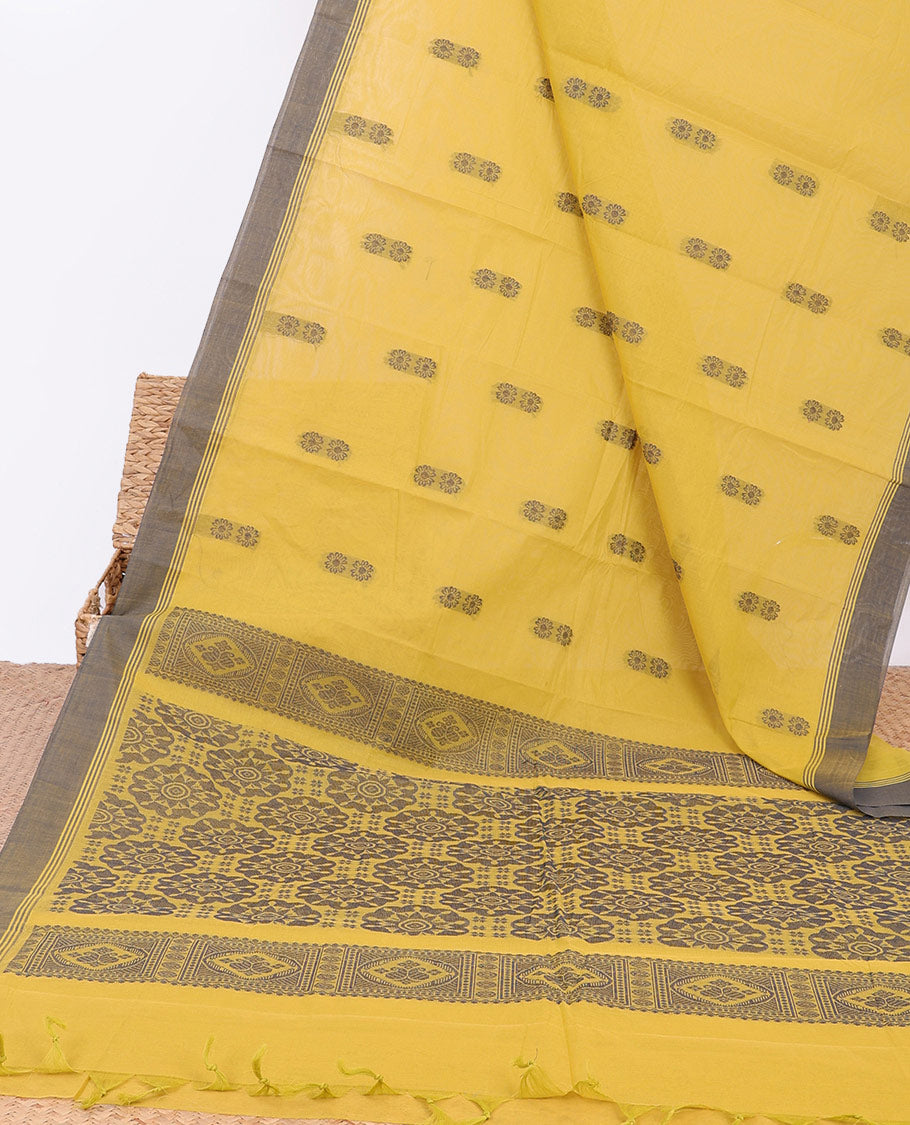 Yellow kanchi cotton saree with floral buttas, contrast border & intricate pallu