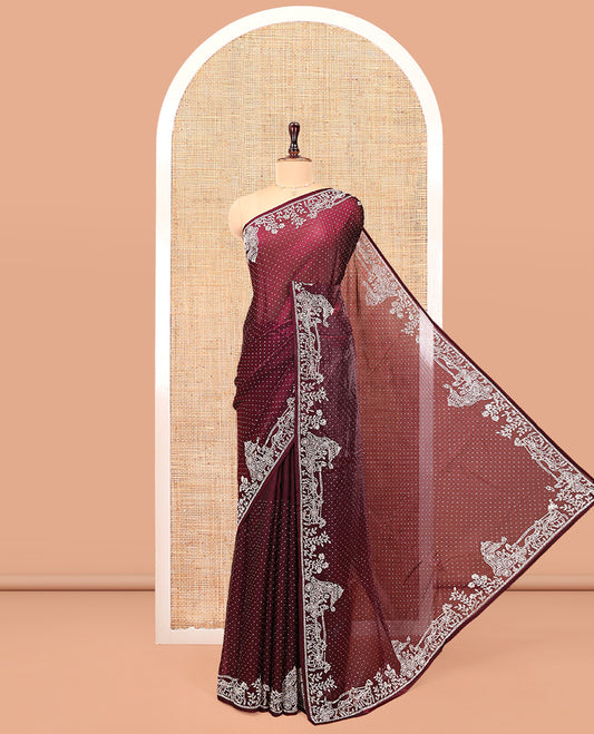 Wine Designer Saree, Scintillated with Stone Struck All Over Its Body, Highlighted by Intricate Stone Work Border, and Paired with a Matching Blouse