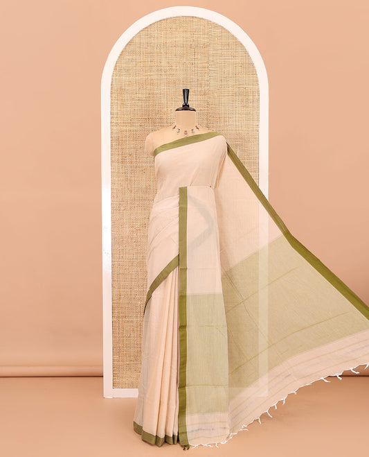 Cream-olive green plain mercerised cotton saree,contrast plain  border, striped pallu, and a contrast plain blouse