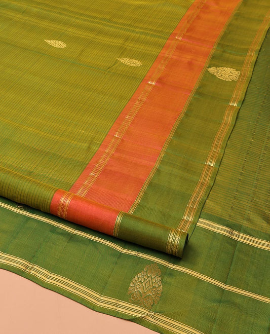 Green Kanchipuram Silk Saree, Mesmerized with Buttas and Vazhaipoo Stripes All Over Its Body, Complemented by a Contrast Border of Muthu, Kathir, and Arumbu Manga Designs, Sparsely Woven Pallu, and Paired with a Contrast Blouse