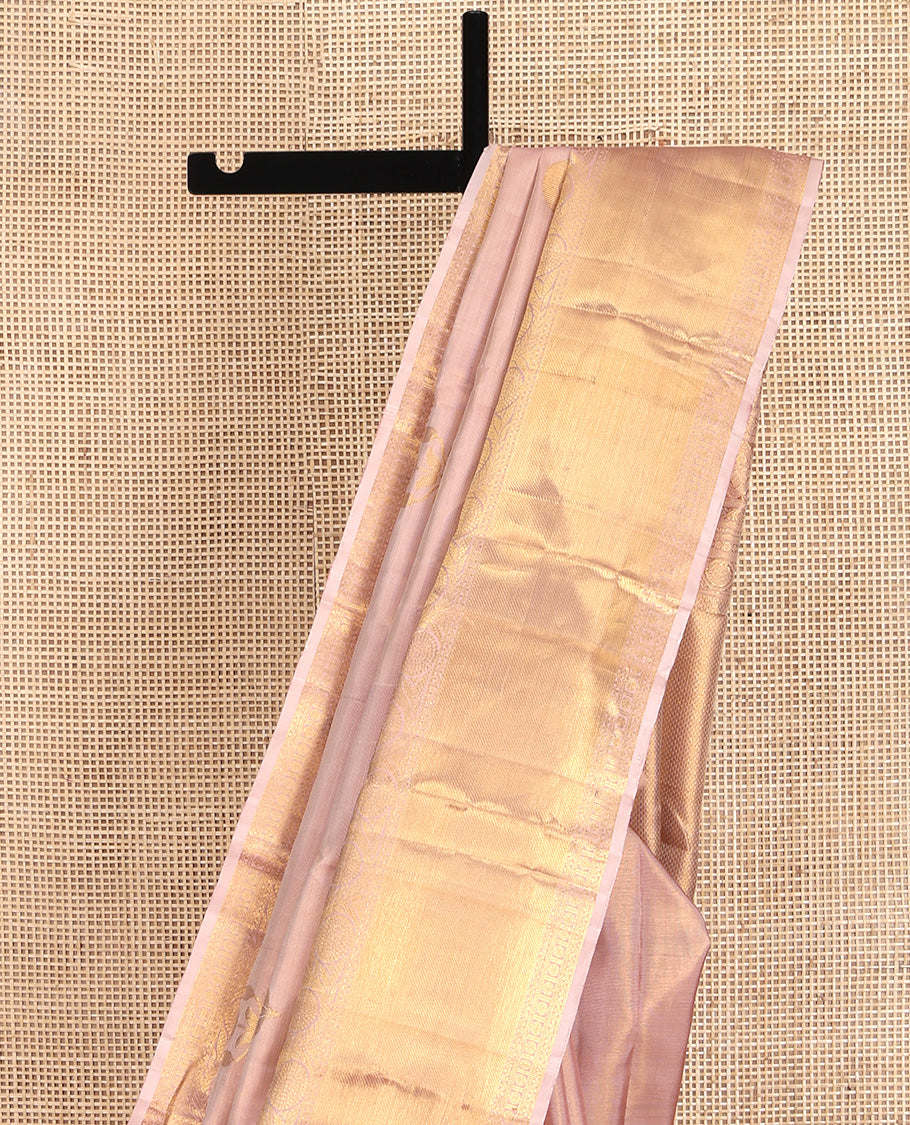 Rose Gold Kanchipuram Silk Saree, Delicately Woven with Floral Buttas All Over Its Body, Highlighted by Zari Border of Thilakam Mokku, Neli, Poun, and Kodi Visiry Designs, Gleaming Pallu, and Paired with a Matching Blouse