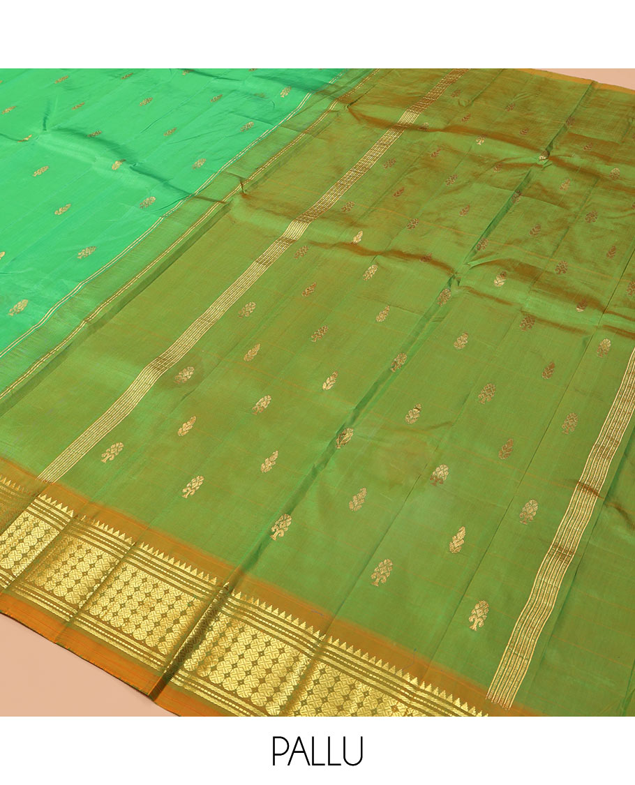 Green Kanchipuram Silk Saree, Styled with Zari Buttas, a Contrast One-Sided Border of Rekku, Banaras, and Rudraksham Designs, Zari Design Pallu, and a No Blouse