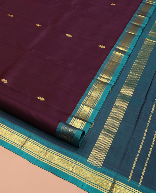 Brown Kanchipuram Silk Saree, Gleamed Up with Zari Buttas on Its Body, Complemented by a Contrast One-Sided Border of Banaras and Jaal Designs, Pallu of Zari Designs, and Comes Without a Blouse