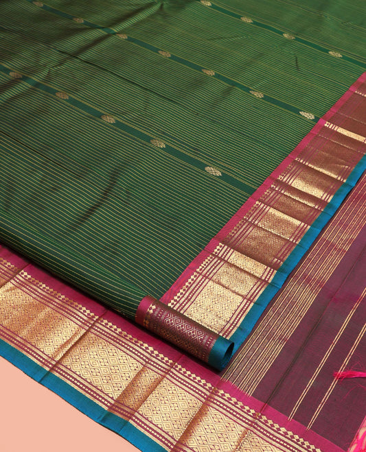 Green Kanchipuram Silk Saree, Adorned with Stripes and Zari Buttas, a Contrast One-Sided Border of Panner Sombu, Banaras, Muthu, and Jaal Design, Zari Design Pallu, and No Blouse