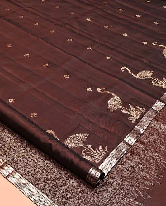 Brown Mayuri Soft Silk Saree, Spotlighted with Zari Buttas All Over Its Body, Highlighted by Piping Zari Border, Intricately Designed Pallu and Paired with a Matching Blouse