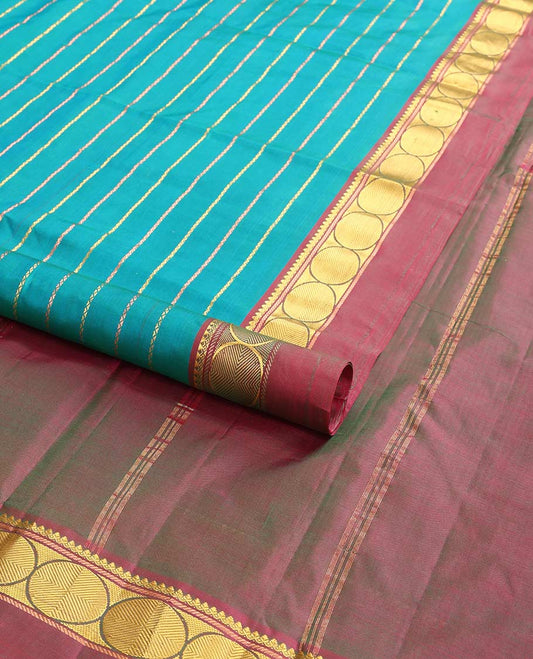Dark blue striped kancheepuram with contrast border of paisley, muthu, kathir design & zari design pallu