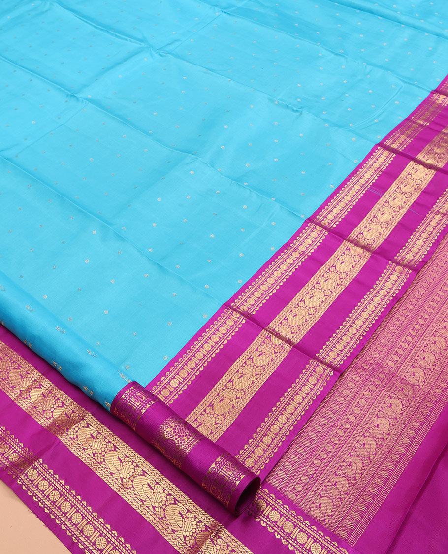 Blue Vasundhara Silk Saree Gracefully Embellished with Zari Buttas, Complemented by a Varisai Pettu Border Featuring Rekku, Muthu, Banaras, Rudraksham, and Mayil Designs, Majestically Woven with a Zari-Designed Pallu, and Paired with a Contrast Blouse