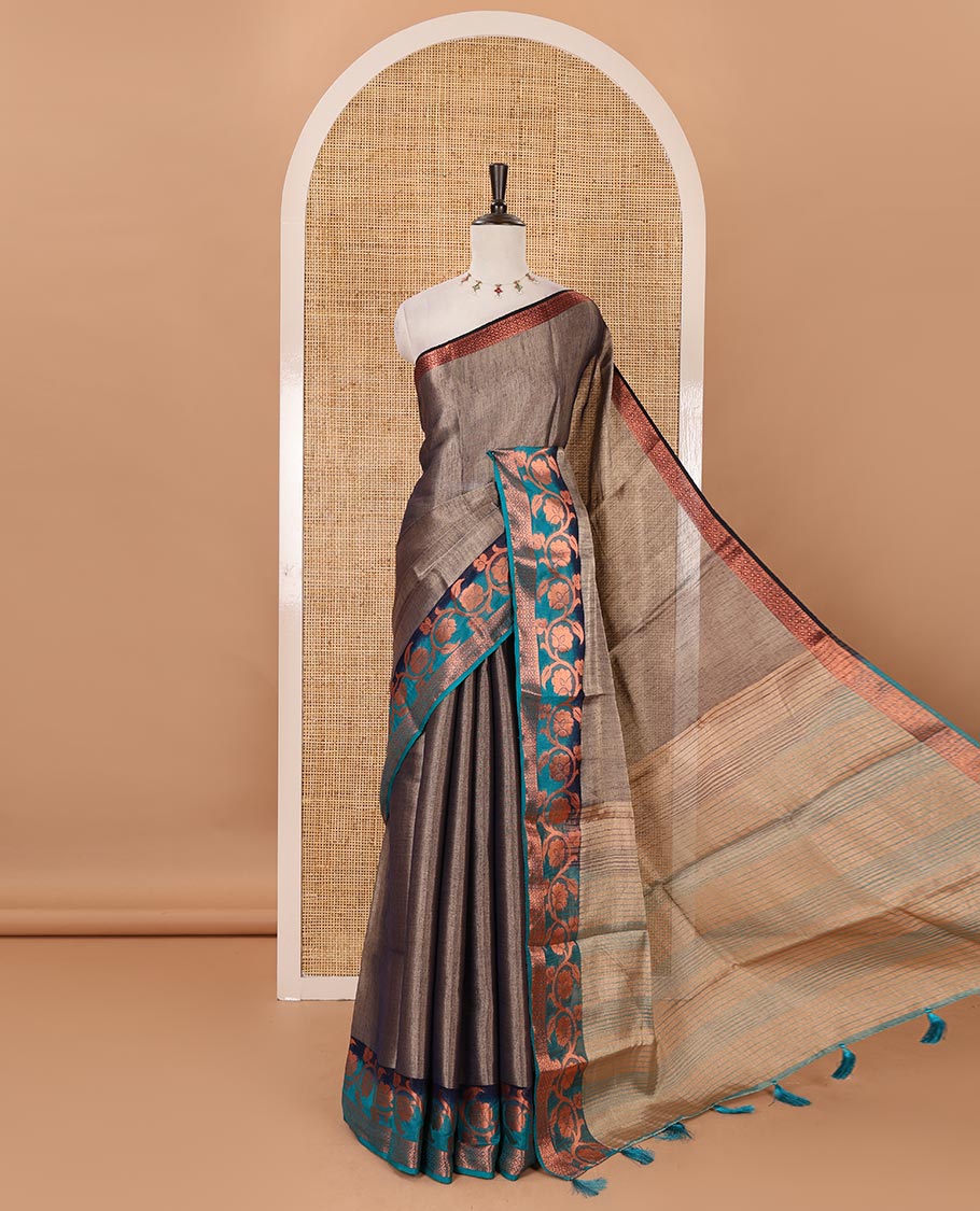 Navy blue plain tissue saree, contrast floral creeper & diamond patterned zari border, striped pallu & contrast plain blouse