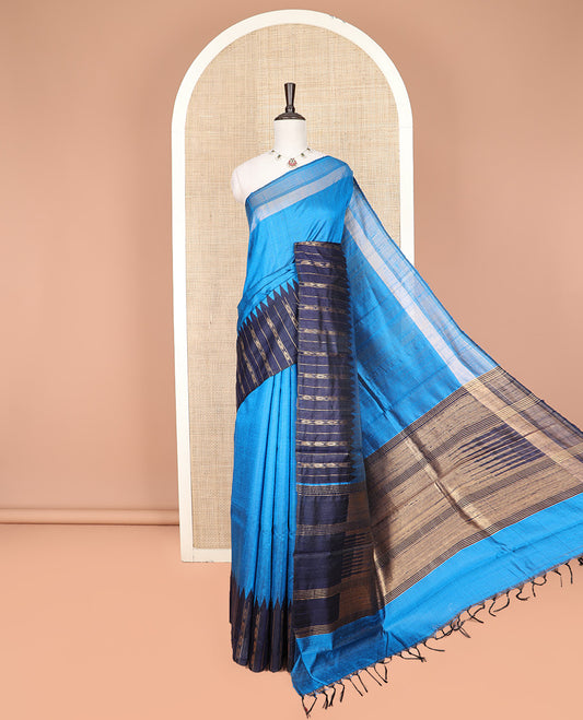 Blue Plain Dupion Silk Saree, Complemented by a Contrast Temple Border of Geometric Patterns, Zari-Rich Pallu of Temple Designs, and Paired with a Contrast Blouse
