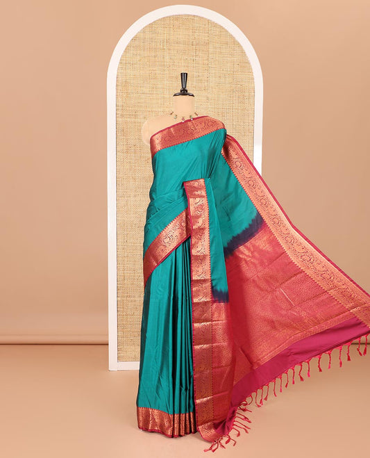 Peacock green plain luxury soft silk saree, contrast traditional temple zari border of elephant motifs, geometric zari pallu, and a contrast jacquard blouse