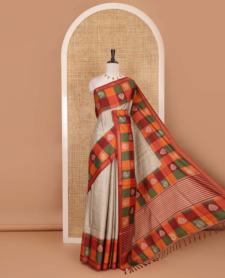 Chikku- orange plain kathan silk saree, contrast buttas enclosed multi-color checked blocks border, temple pallu, and contrast blouse of checks, and buttas