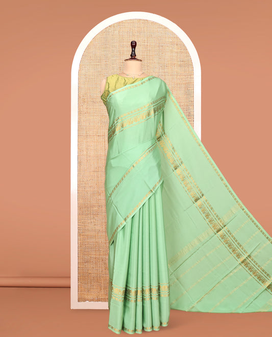 Green Plain Mysore Silk Saree, Highlighted by Traditional Zari Border of Elephant Motifs, Subtly Zari Striped Pallu, and Paired with a Matching Blouse