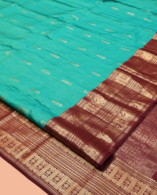 Green Vasundhara Lite Silk Mix Saree, Decked Up with Buttas and Stripes, Complemented by a Contrast Border of Bentex, Mayil Kann, Mayil, and Chakra, Intricate Pallu, and a Contrast Blouse