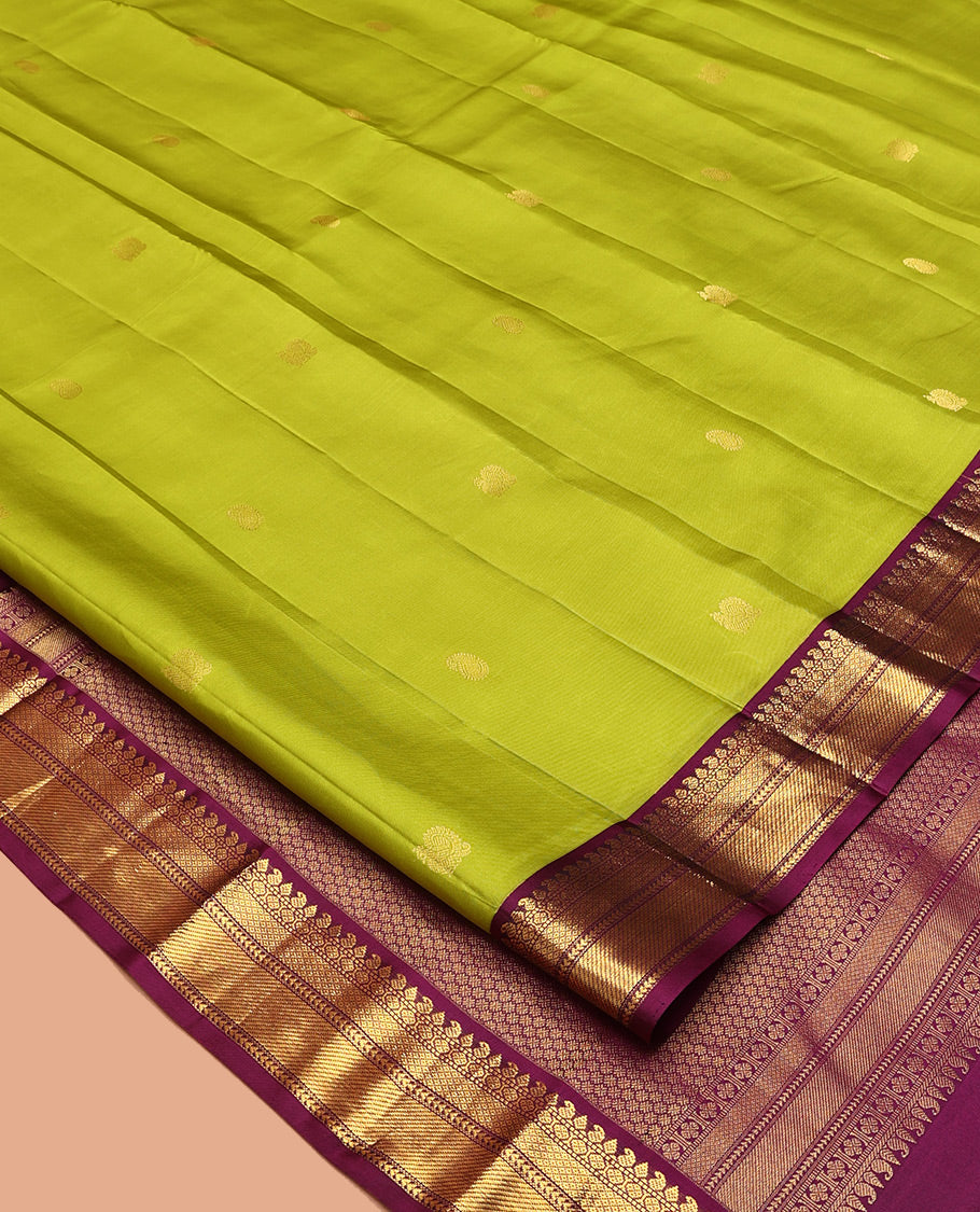 Green Vasundhara Silk Saree, Prettified with Zari Buttas All Over Its Body, Complemented by a Contrast Border of Thilakam, Manga, Muthu, Ara Bogudi, and Mayil Kann Designs, Grand Pallu, and Paired with a Contrast Blouse